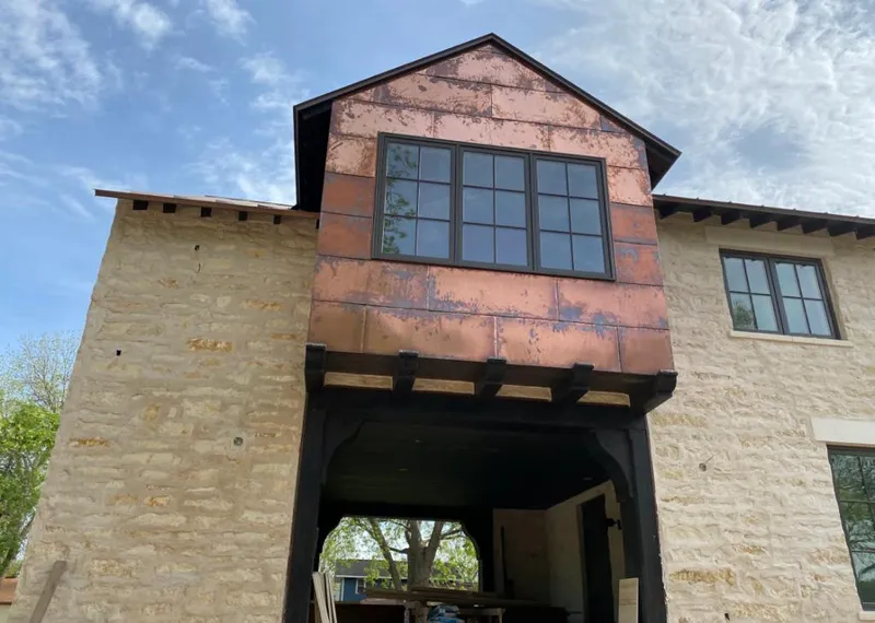 Copper metal panel facade on a stone building for Skylight Installation in Rosendale